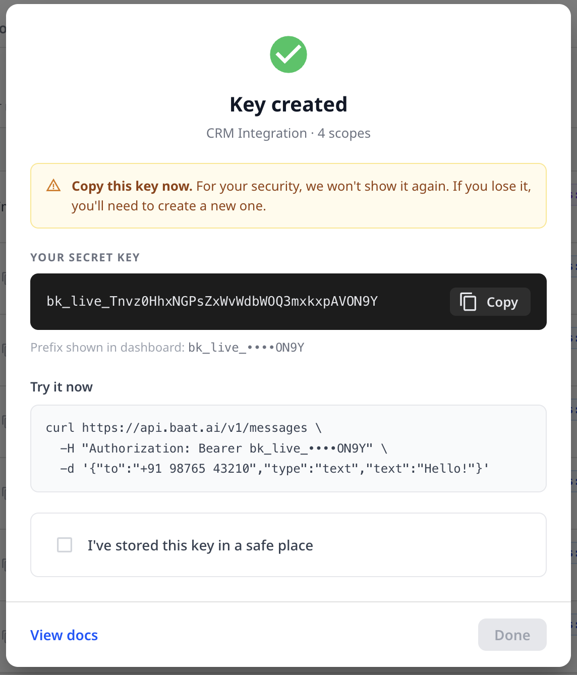 Key created confirmation modal showing the full bk_live secret key once, a copy button, the masked dashboard prefix, and an 'I've stored this key in a safe place' checkbox